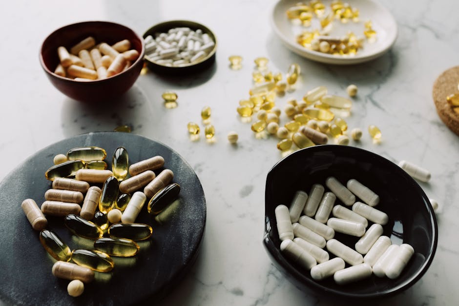 From above of varied medical capsules and tablets sorted into different dishes for treatment on marble table in hospital