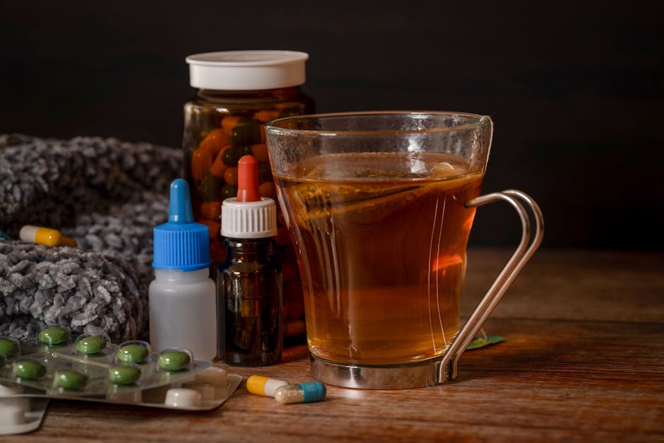 A cup of herbal tea with medications suggests natural cold remedies for healing.