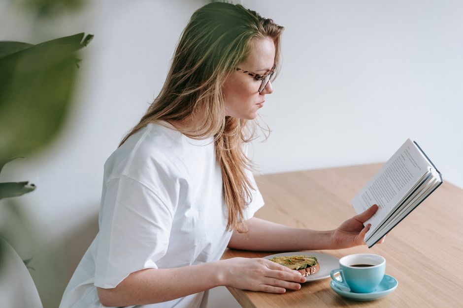Woman reading calmly in bed during an evening wind-down